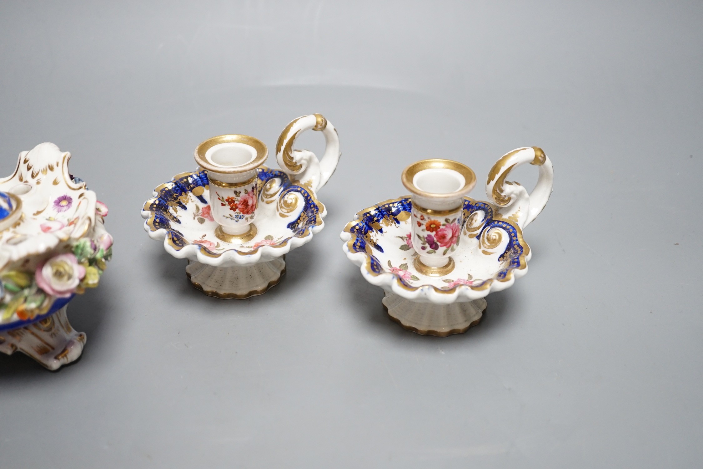 A Coalport floral encrusted inkwell cover and liner, marked C-Dale in blue and two English porcelain tapersticks painted with roses perhaps Coalport, c.1820